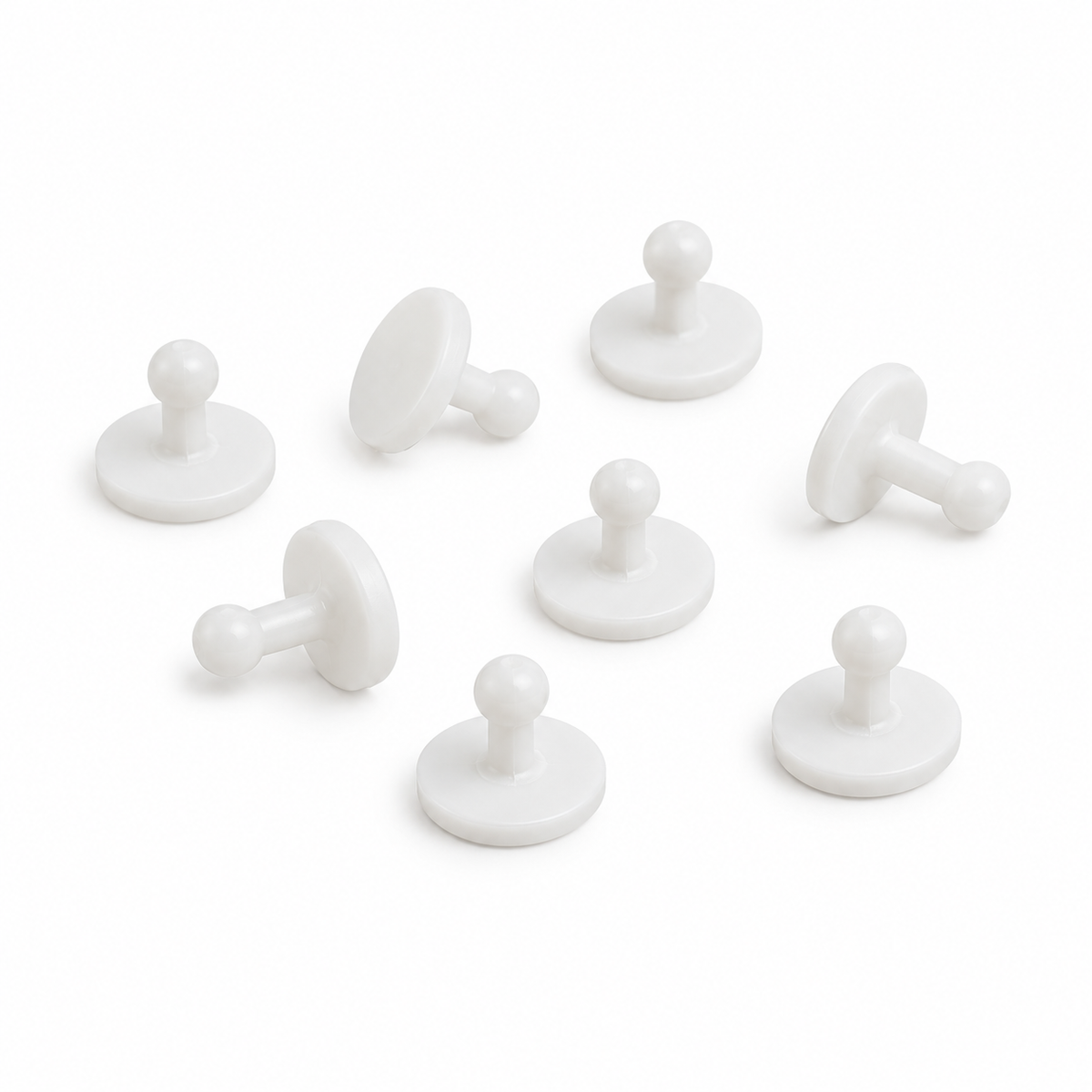 White plastic shirt cuff studs — product illustration